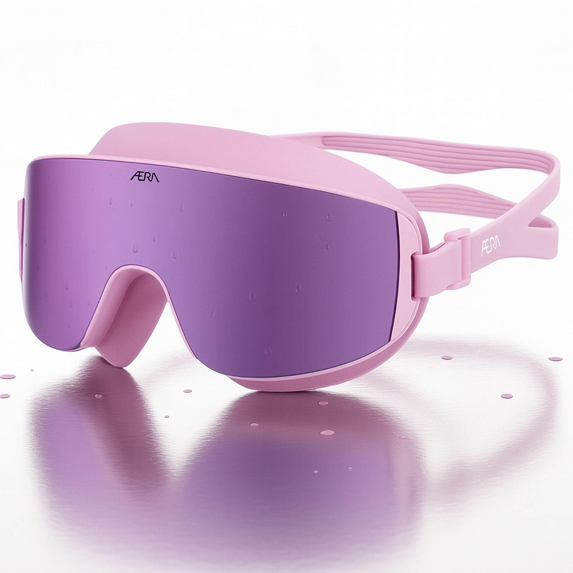 ÆRA Blushwave swimming goggles in pink and purple with AERA branding on white background, featuring anti-fog lenses and UV protection for adults
