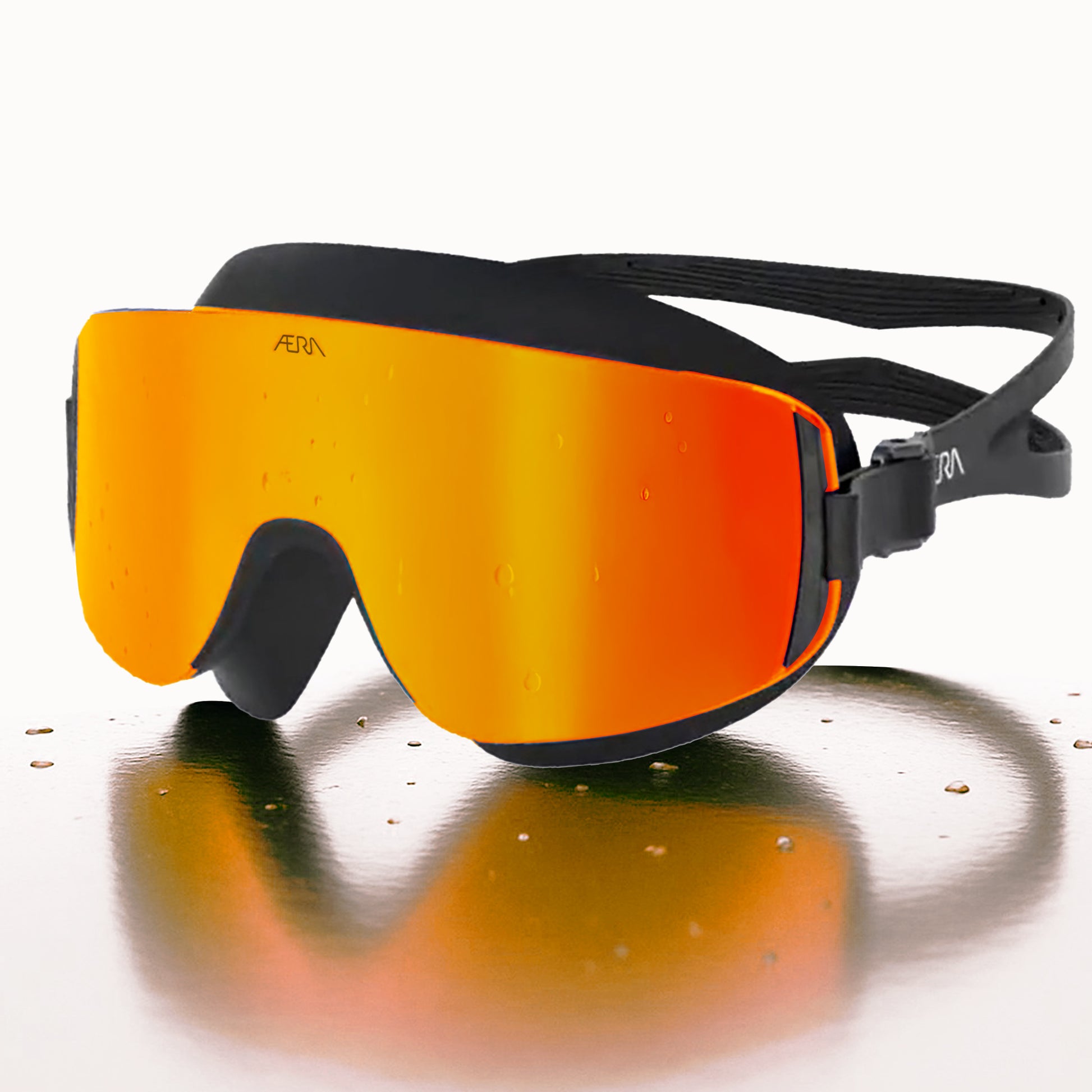 ÆRA Fire swimming goggles in red and orange with AERA branding on white background, featuring anti-fog lenses and UV protection for adults