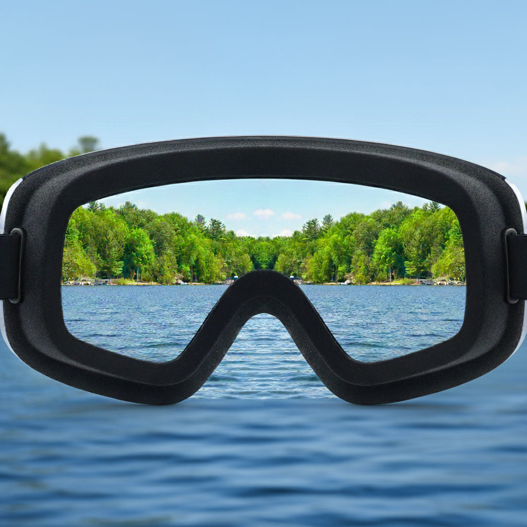 Black diving mask with a scenic view of a lake and trees in the background
