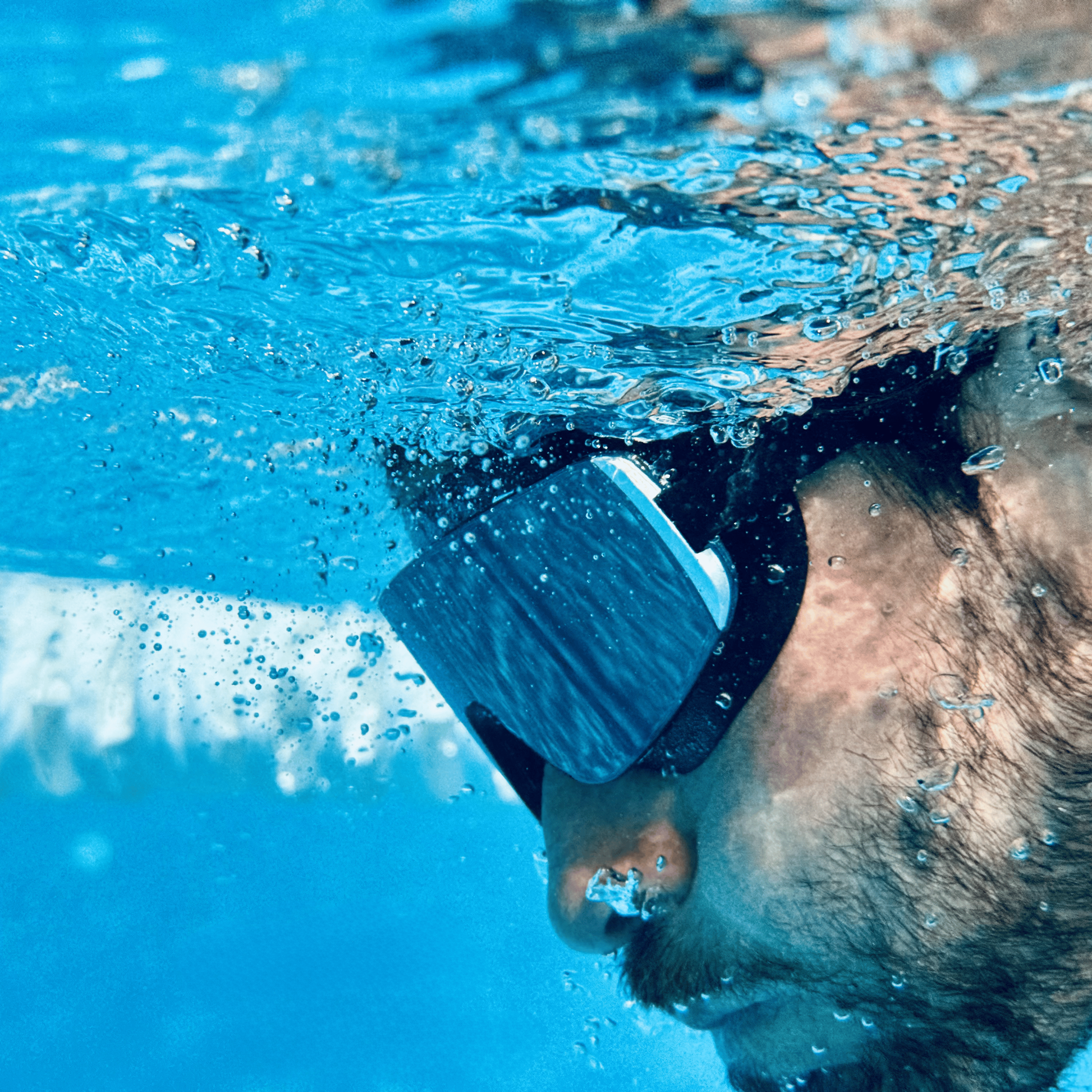 Male swimmer underwater wearing AERA Sports Black Mirror Lens