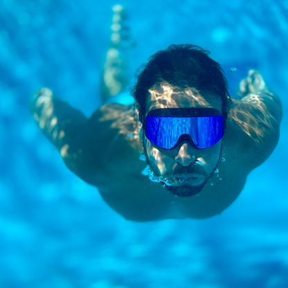 Male swimmer underwater wearing AERA Sports Blue Steel Lens