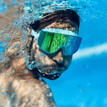 Male swimmer underwater wearing AERA Sports Emerald Lens
