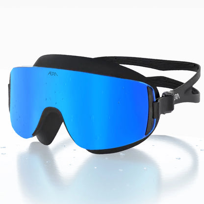 ÆRA Blue Steel swimming goggles in blue and black with AERA branding, featuring anti-fog lenses and UV protection for adults.