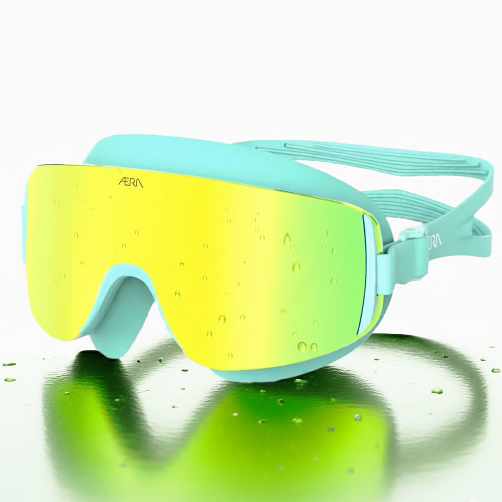 ÆRA Emerald swimming goggles in yellow and green with AERA branding on white background, featuring anti-fog lenses and UV protection for adults