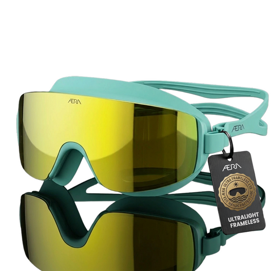 ÆRA Emerald swimming goggles in yellow and green with AERA branding on white background, featuring anti-fog lenses and UV protection for adults