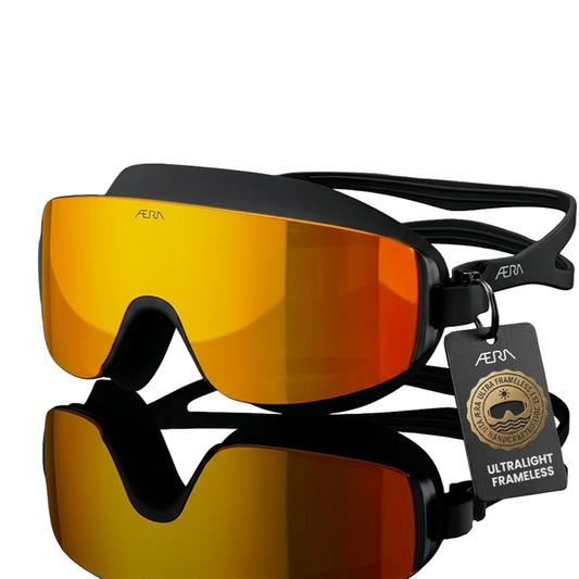 ÆRA Fire swimming goggles in red and orange with AERA branding on white background, featuring anti-fog lenses and UV protection for adults