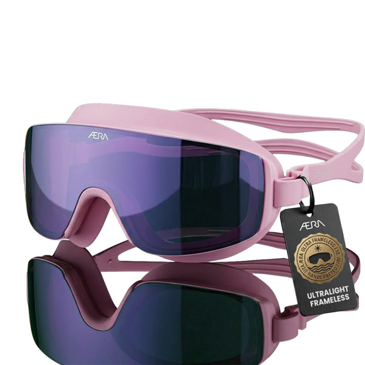 ÆRA Blushwave swimming goggles in pink and purple with AERA branding on white background, featuring anti-fog lenses and UV protection for adults
